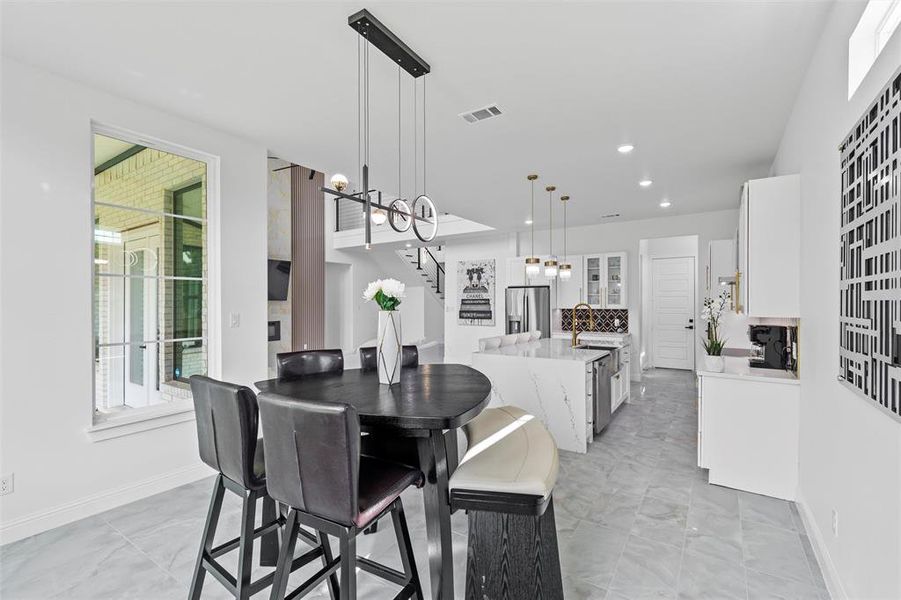 Open-concept living space featuring light-toned tile flooring throughout