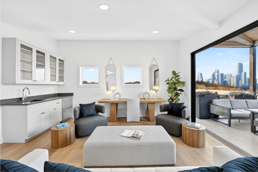Living area with light wood-style flooring, recessed lighting, and beamed ceiling