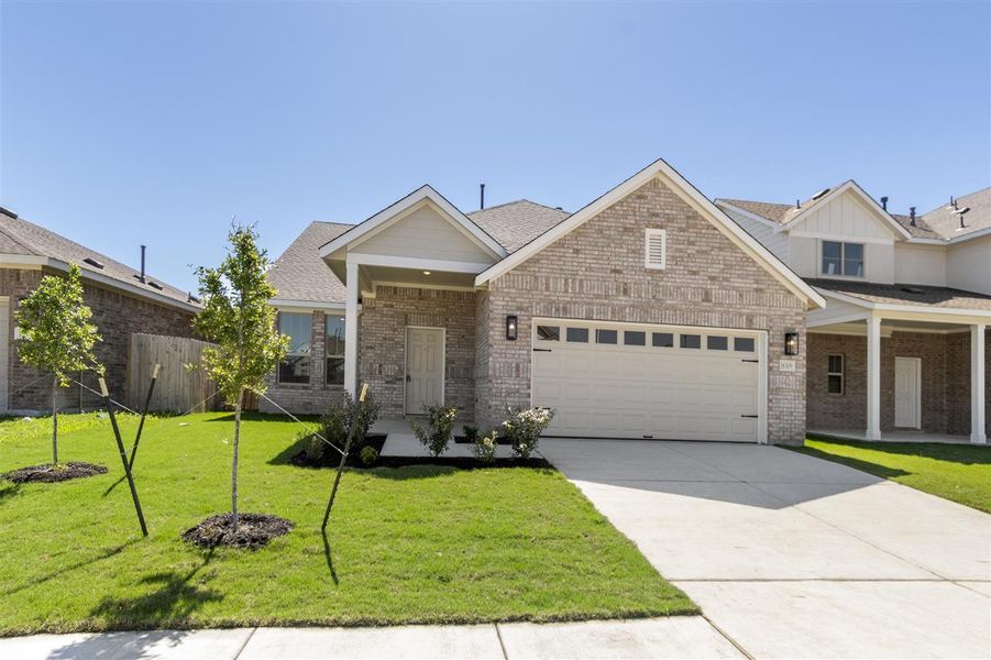 View of front of property with a garage, brick siding, a front lawn, and concrete driveway View of front of property with a garage, brick siding, a front lawn, and concrete driveway