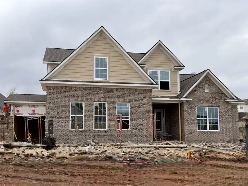 View of front of home with brick siding, a porch, and a shingled roof View of front of home with brick siding, a porch, and a shingled roof