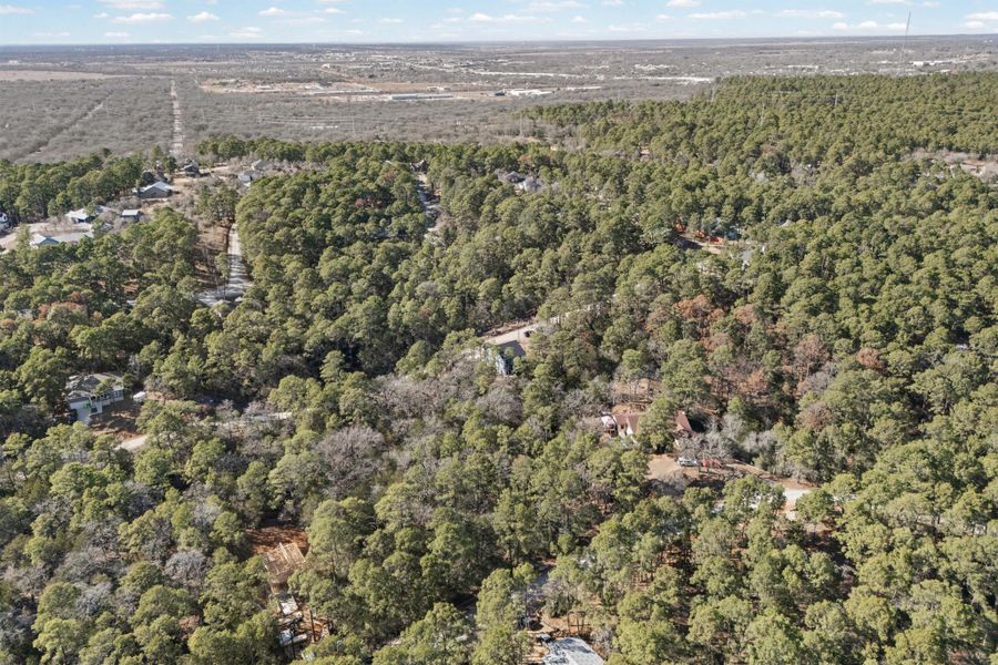 View of property location featuring a forest