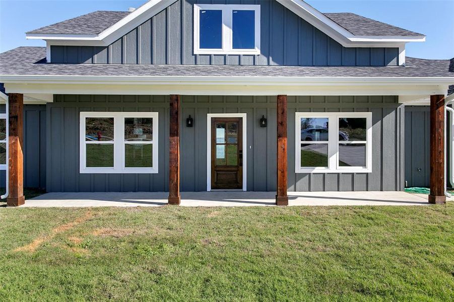 Property entrance with a yard and a porch