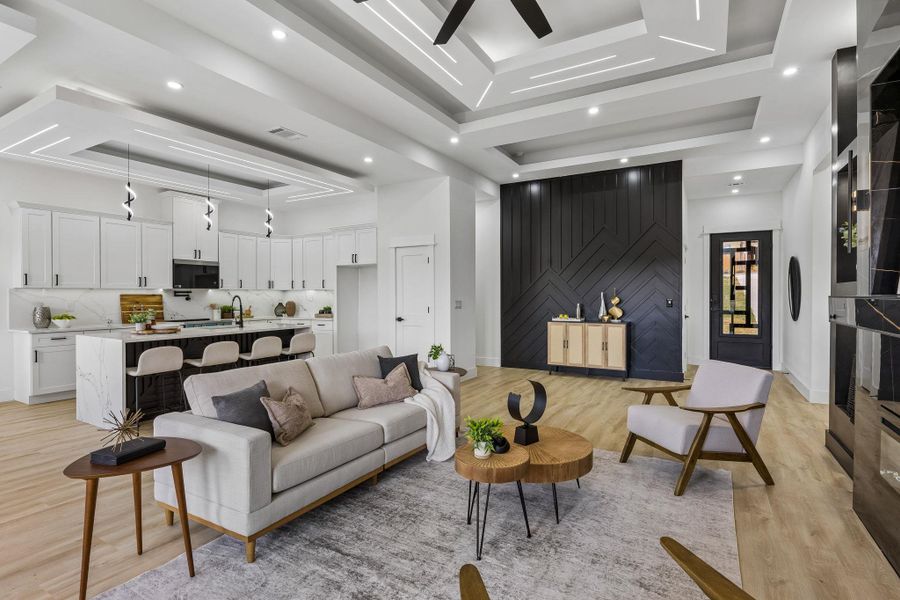 Gleaming hardwood floors and a recessed tray ceiling define this open-concept main level.