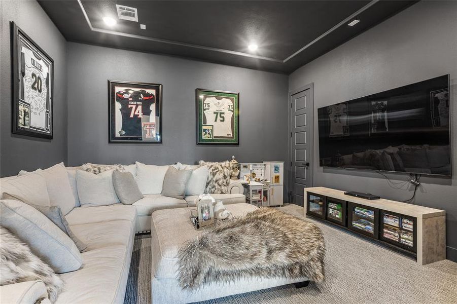A one story home with a media room! Dark designer wall color and upgraded carpet create the perfect movie night experience
