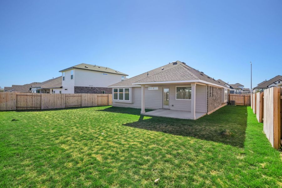 Exterior details and patio area of a home in Village at Three Oaks, Seguin (Image 18).