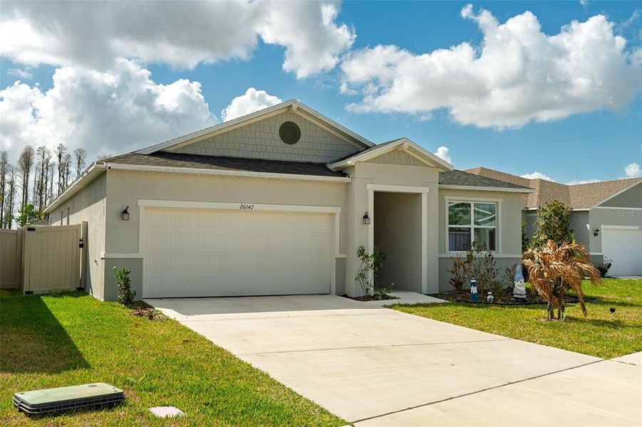 Front exterior of a new home in , Land O' Lakes, FL, highlighting curb appeal (Image 20).