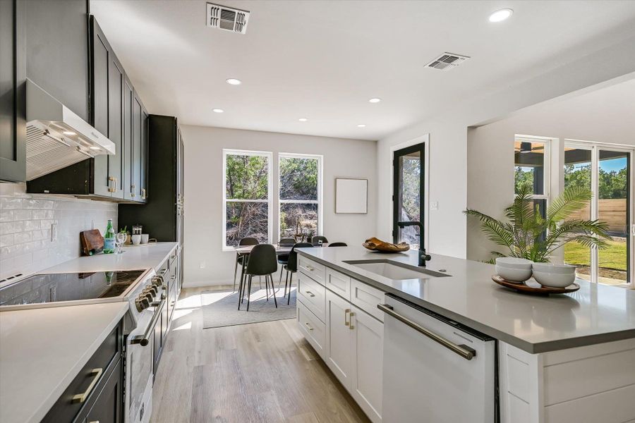 Sun-filled kitchen boasts modern appliances and a seamless connection to outdoor living.