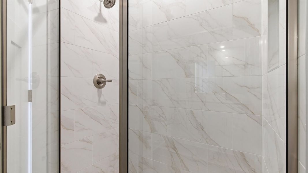Highly functional and elegant en-suite with dual vanities, tiled walk-in shower, and refined finishes