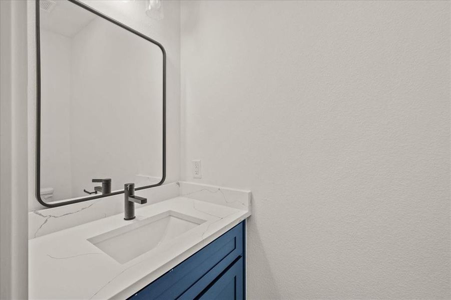 Bathroom featuring vanity and toilet