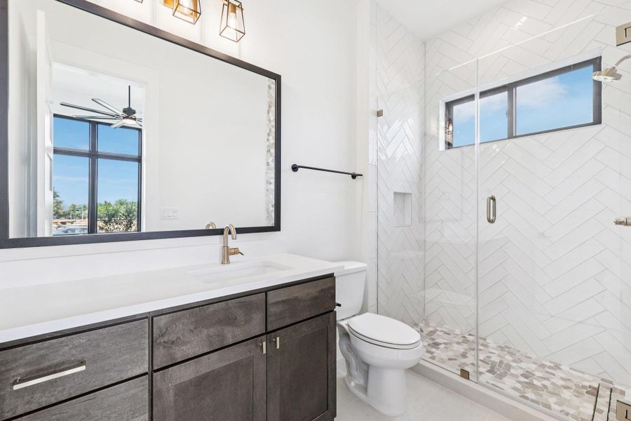Bathroom with vanity and a stall shower