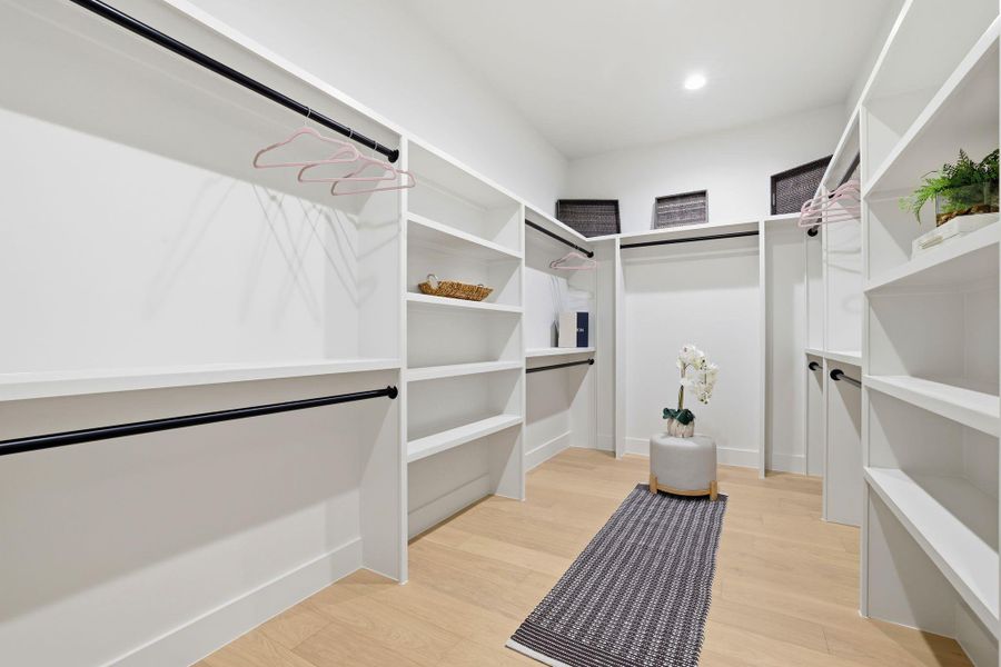 Walk in closet featuring light wood-style flooring