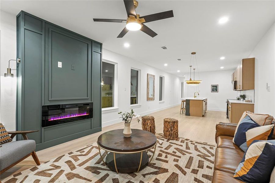 Living area with light wood-style floors, recessed lighting, and ceiling fan