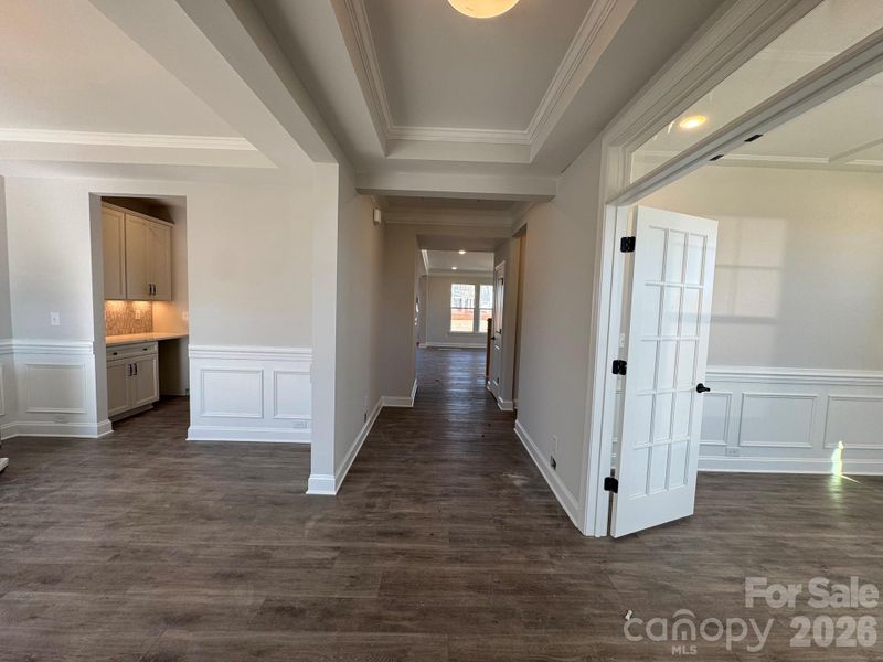 Foyer flanked by dining room and office