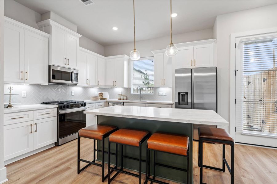 The kitchen island naturally becomes the heart of the home, bringing people together for both everyday use and entertaining.