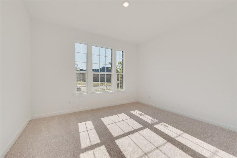 Empty room featuring light colored carpet