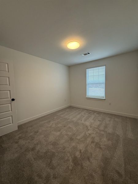 Carpeted empty room with baseboards