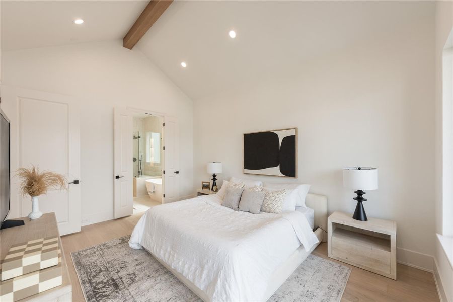 Wake up, walk ten steps, step into the shower. The en suite sits just off the primary, framed by a paneled door that closes the room off in one clean line. Above it all, the pitched ceiling and warm-wood beam quietly remind you the house was drawn with intention.