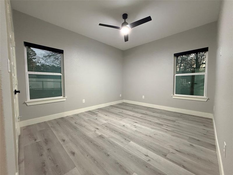 Empty room featuring light wood-style flooring and a ceiling fan