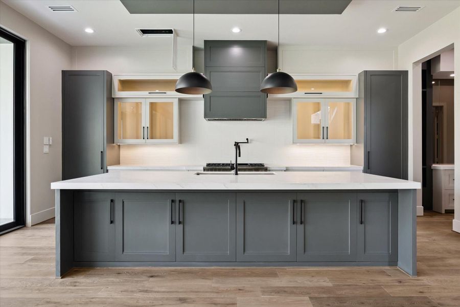 The impressive island serves as the centerpiece of the kitchen, featuring an integrated sink, expansive workspace, and abundant storage. With seating for 5–6, it effortlessly combines functionality and style, creating the perfect hub for both meal preparation and casual gatherings.