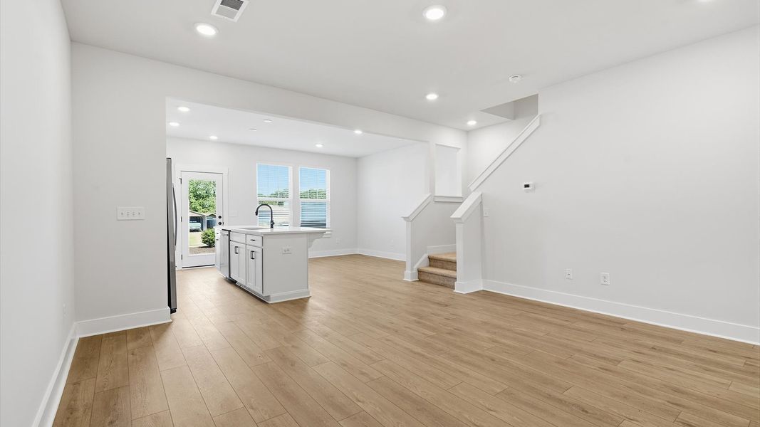First-rate living space with tasteful hardwood floors and a functional open-concept design by DRB Homes First-rate living space with tasteful hardwood floors and a functional open-concept design by DRB Homes