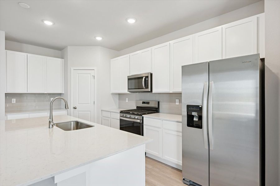 A kitchen with white cabinets. A kitchen with white cabinets.