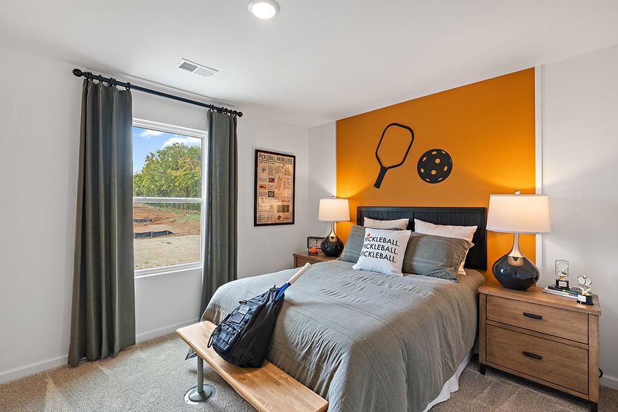 A bedroom with a large window. A bedroom with a large window.