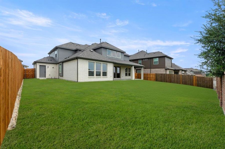 Front exterior of a new home in Woodcreek, Fate, TX, highlighting curb appeal (Image 15). Front exterior of a new home in Woodcreek, Fate, TX, highlighting curb appeal (Image 15).