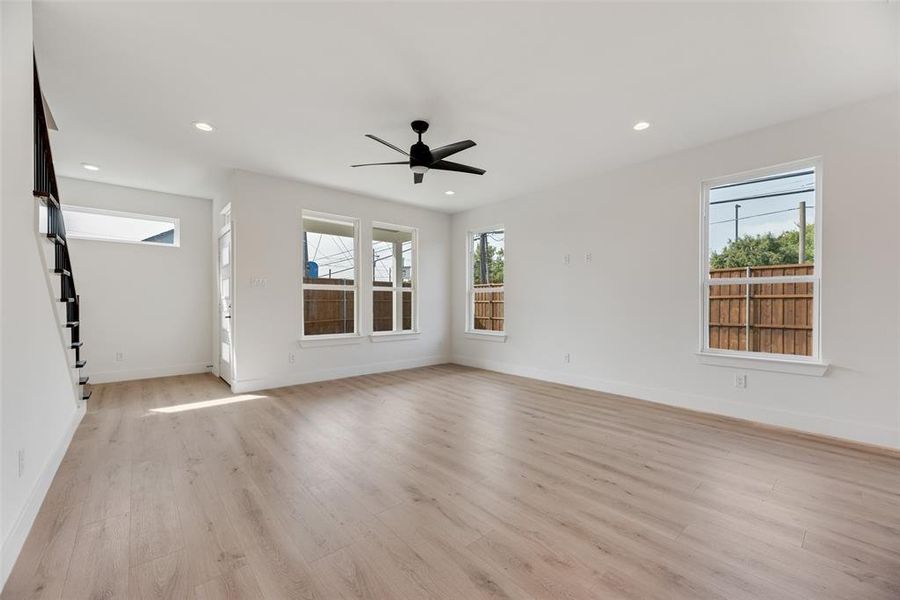 Unfurnished room featuring recessed lighting, light wood-style floors, stairway, and ceiling fan