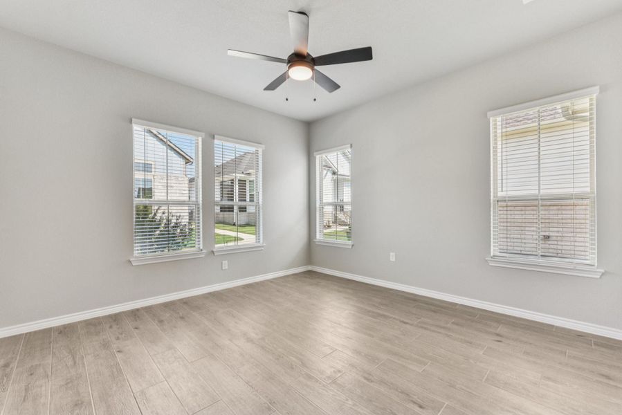 Unfurnished room featuring light wood-type flooring and a ceiling fan Unfurnished room featuring light wood-type flooring and a ceiling fan