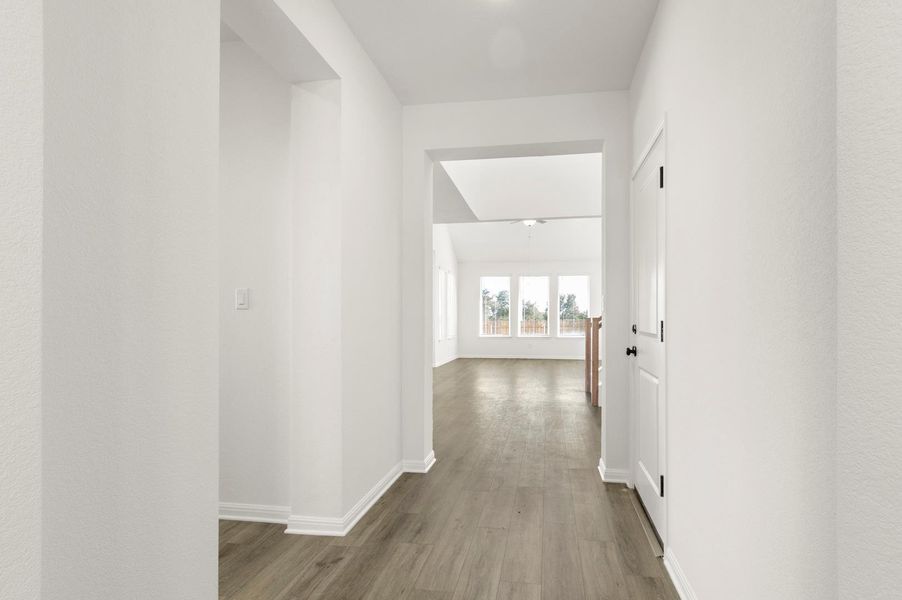 Hallway featuring dark wood-type flooring and baseboards