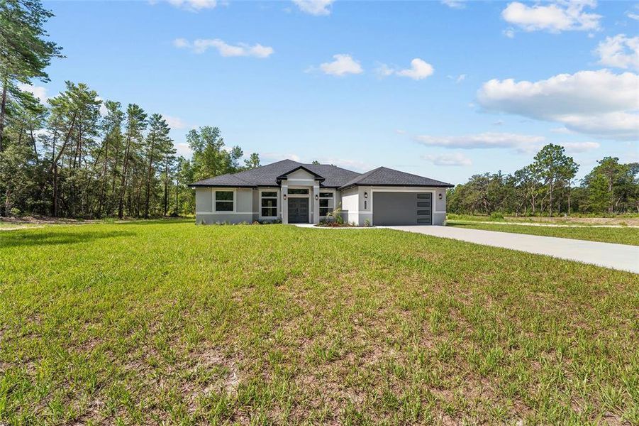 Front exterior of a new home in , Ocala, FL, highlighting curb appeal (Image 2). Front exterior of a new home in , Ocala, FL, highlighting curb appeal (Image 2).