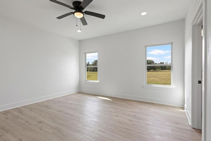 Empty room with light wood-style floors, recessed lighting, and a ceiling fan