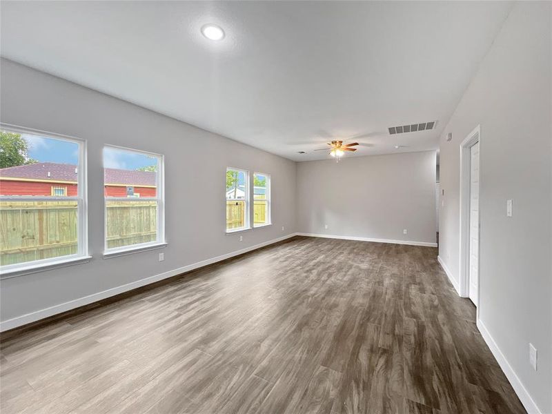 Empty room with hardwood / wood-style flooring and ceiling fan