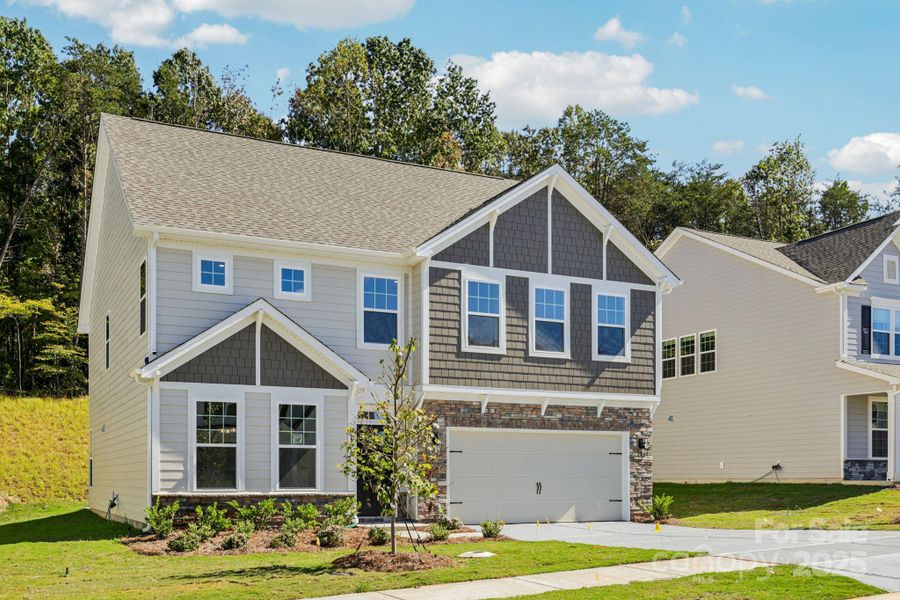 Front exterior of a new home in Falls Cove, Troutman, NC, highlighting curb appeal (Image 1).