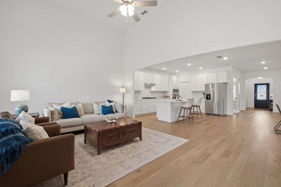 Soaring ceilings, a cozy fireplace, and walls of windows make this living room feel bright, spacious, and inviting. The open layout at 905 Bluebell St in Princeton, TX gives buyers the better-than-new home feel they want without the wait.