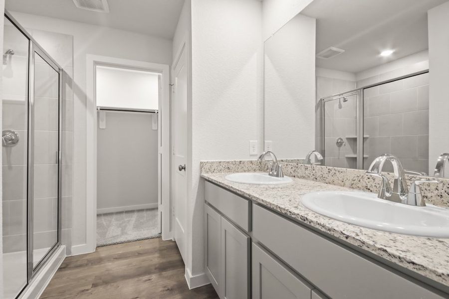 A bathroom with a glass shower. A bathroom with a glass shower.