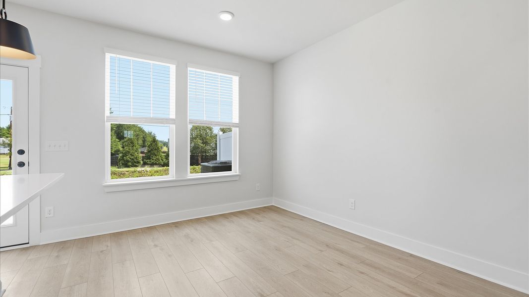 Open-concept breakfast area with seamless flow into the kitchen and family room