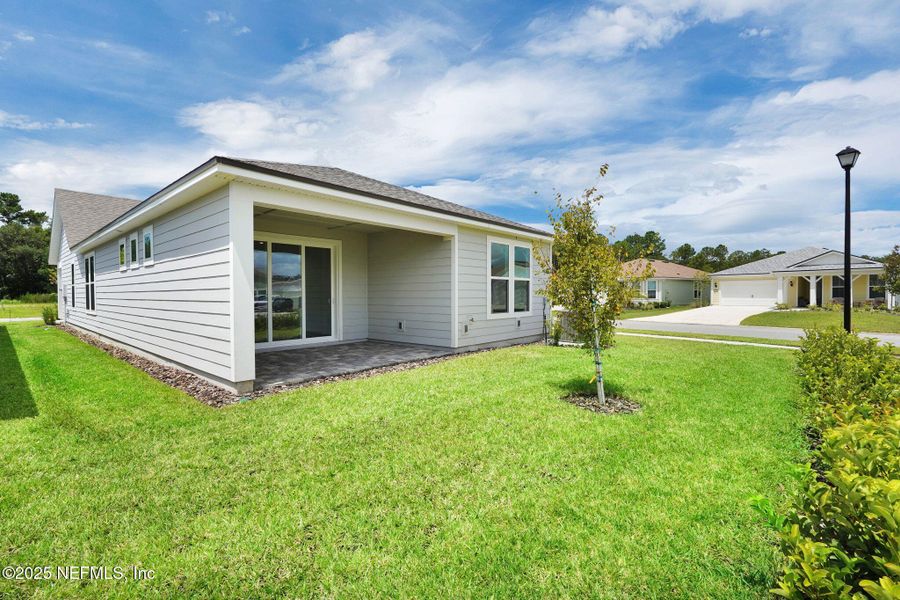 Front exterior of a new home in Summer Bay at Grand Oaks, St. Augustine, FL, highlighting curb appeal (Image 21).