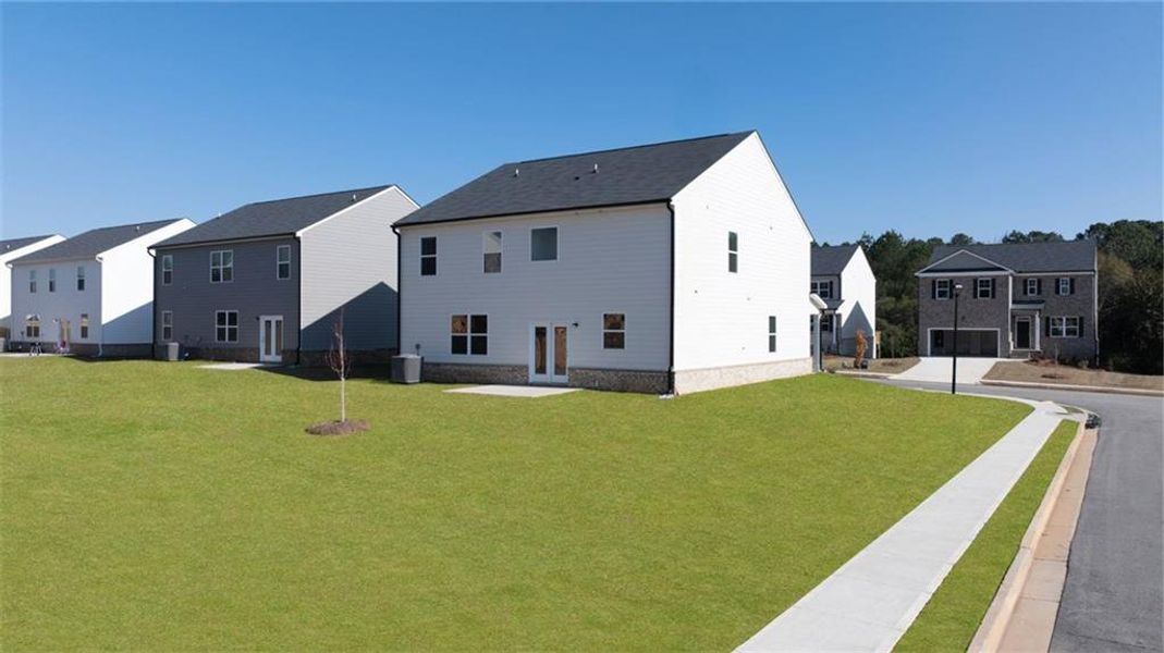 Front exterior of a new home in The Reserve at Calcutta, Stockbridge, GA, highlighting curb appeal (Image 17). Front exterior of a new home in The Reserve at Calcutta, Stockbridge, GA, highlighting curb appeal (Image 17).