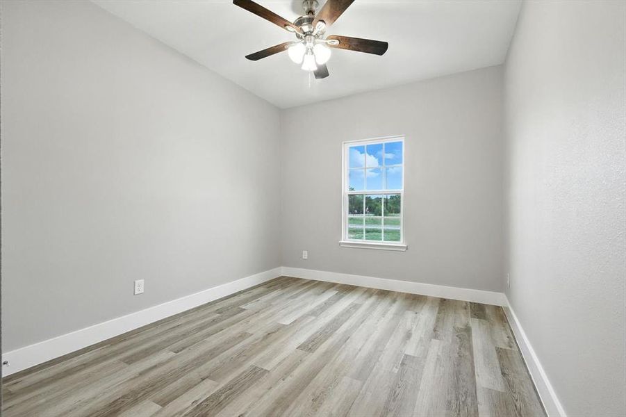 Unfurnished room with light wood-type flooring and ceiling fan Unfurnished room with light wood-type flooring and ceiling fan