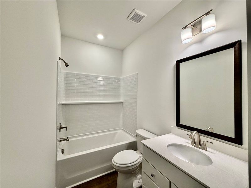 Crisp subway tile surrounds a soaking tub in this