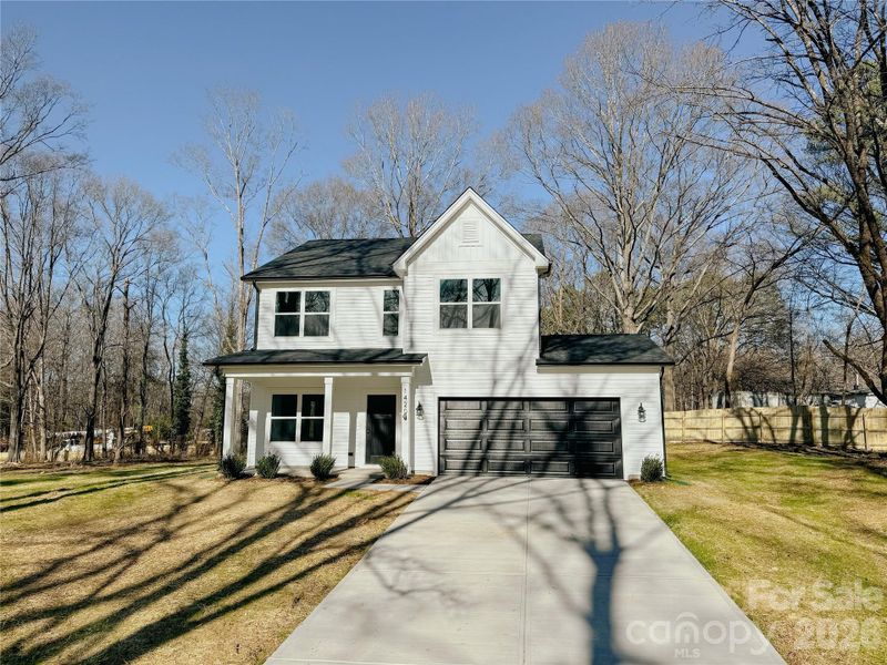 Front exterior of a new home in , Huntersville, NC, highlighting curb appeal (Image 17).