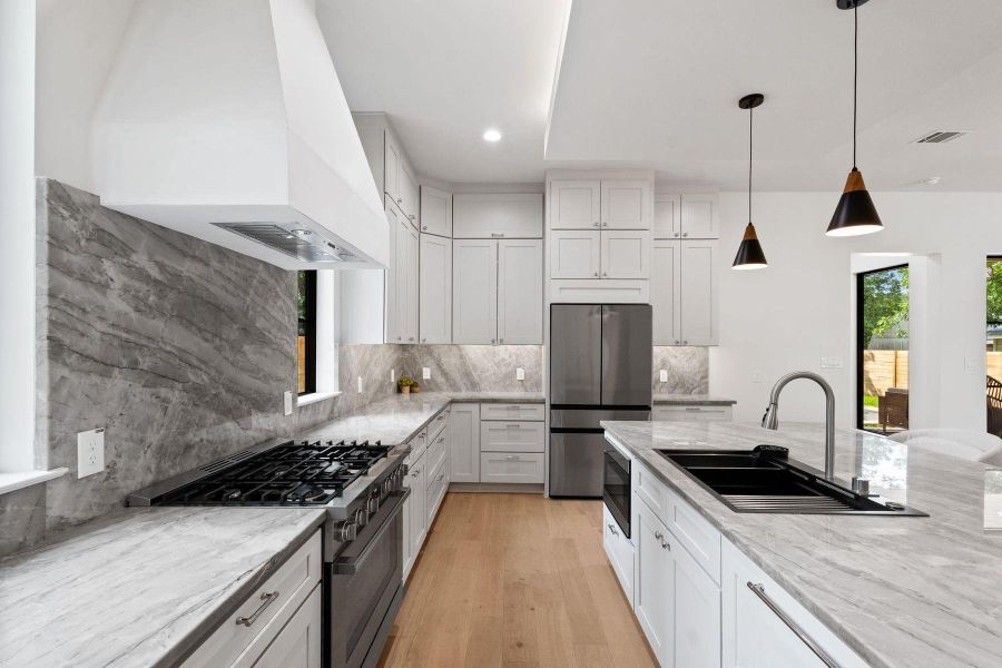 Culinary delights await in this bright kitchen with premium appliances and an inviting island. Culinary delights await in this bright kitchen with premium appliances and an inviting island.