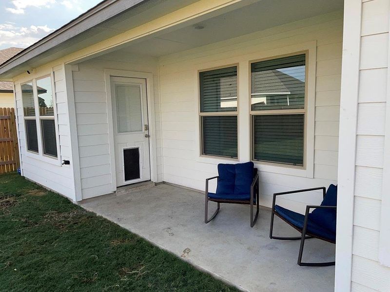 Doorway to property featuring a patio