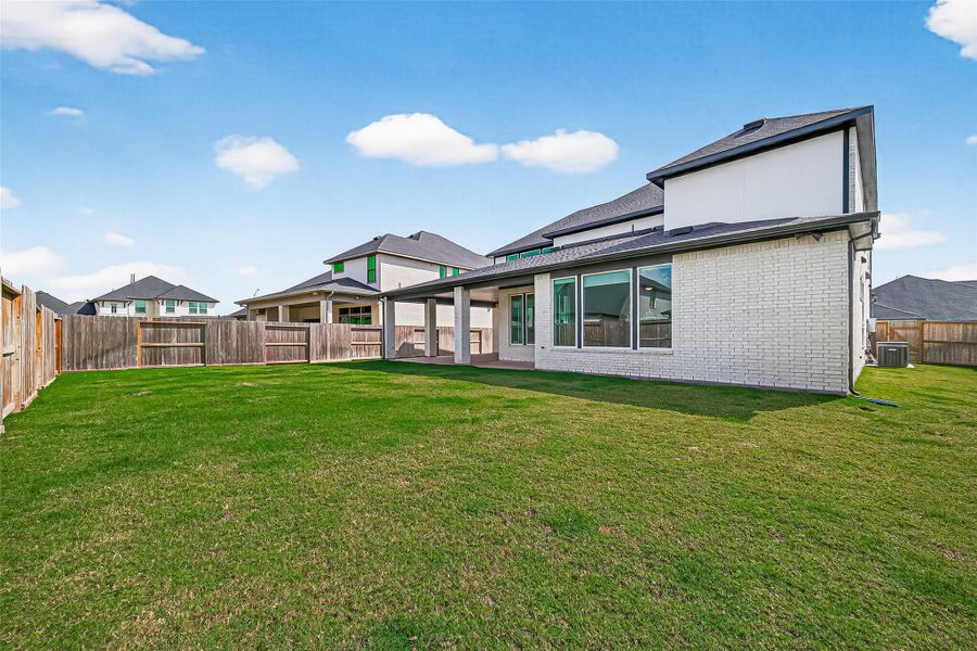 Wrap around covered patio overlooks the backyard.