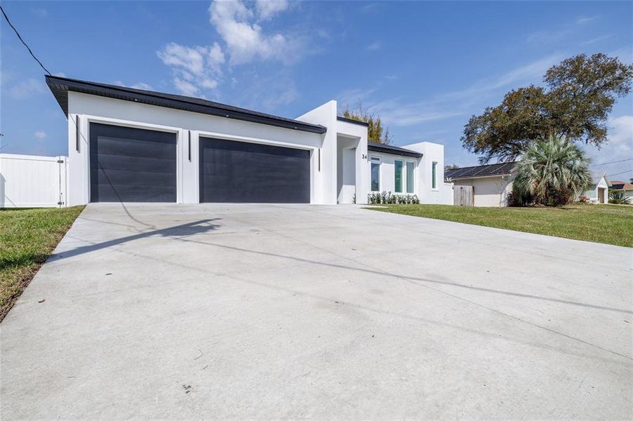 Front exterior of a new home in , Palm Coast, FL, highlighting curb appeal (Image 24).
