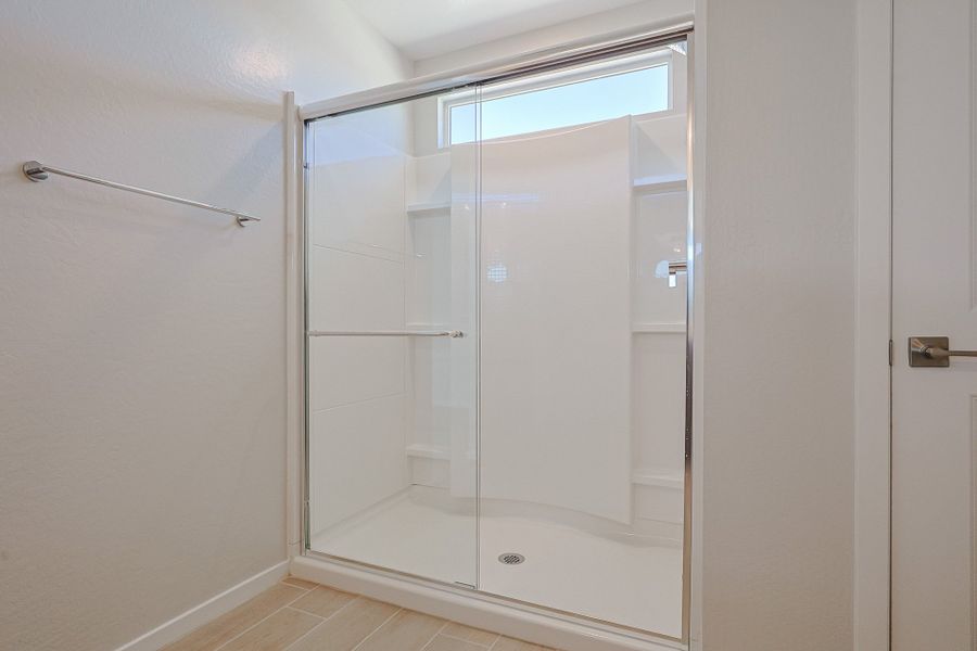 A shower with a glass door. A shower with a glass door.
