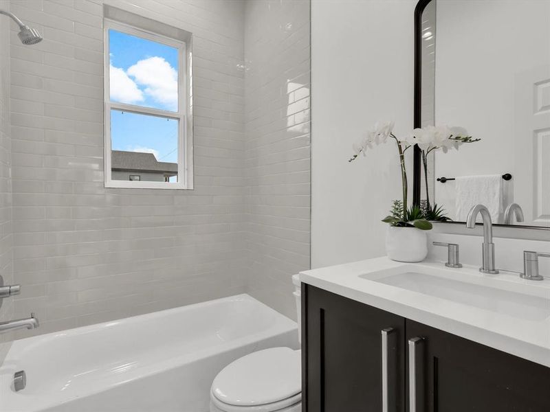 Full bathroom with vanity, toilet, and tiled shower / bath