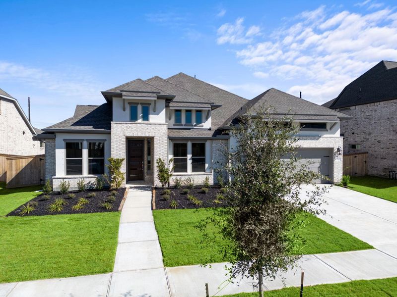 Front exterior of a new home in Valencia 70', Manvel, TX, highlighting curb appeal (Image 1).