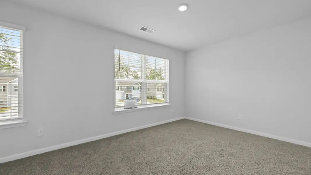 Spacious, unfurnished interior of a new home in Pine Hills Townhomes at Cane Bay, Summerville (Image 23). Spacious, unfurnished interior of a new home in Pine Hills Townhomes at Cane Bay, Summerville (Image 23).
